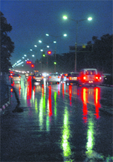 A road lights up with colour after rain at Sector 16, Chandigarh,
