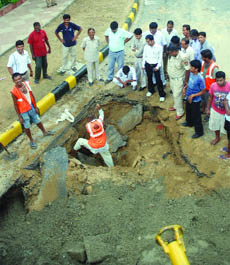 The caved-in portion of the road near Hyderabad House in New Delhi on Monday.