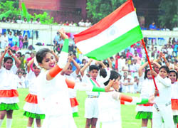 Schoolchildren perform during the Independence Day celebrations at Karna Stadium in Karnal on Sunday.