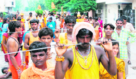 Devotees perform daring acts during a religious procession in Karnal.