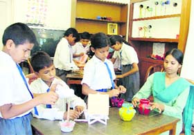 Students of Gyan Ghar learn the art of creating best out of waste with the help of their teacher in Ludhiana