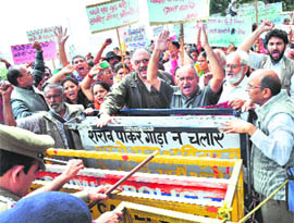 Activists of the Kheti Bachao Sangharsh Samiti protest in front of the Vidhan Sabha in Shimla on Wednesday.