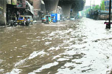 Knee-deep water outside the railway station makes vehicular movement difficult in Ludhiana. 