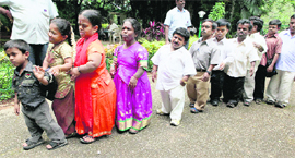 Dwarfs from various parts of Karnataka stand in a queue after they announce the formation of their association to demand state benefits for physically challenged persons in Bangalore 