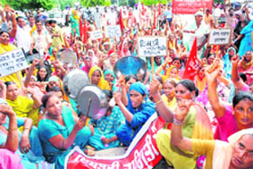 Members of the Istri Jagriti Manch stage a protest over the delay in the grant of widow pension, atrocities against women, price rise, the poor public distribution system and the rotting of foodgrains in godowns, in front of the Deputy Commissioners office in Jalandhar on Wednesday. 