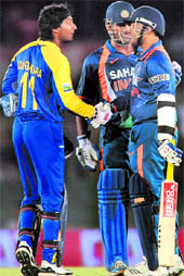 Kumar Sangakkara (L) speaks to Virender Sehwag after the controversial no-ball