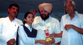 Harjit Singh Grewal, chairman of the Punjab Infotech, giving away prize to a meritorious student in Bathinda on Thursday.