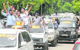 Supporters of the SOI take out a car rally at Panjab University, Chandigarh, on Thursday