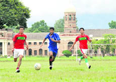 Players vie to take control of the ball in a match of the Regional Sports Football Tournament on the FRI campus in Dehradun on Thursday.