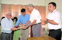 Dr R.P.S. Tyagi, a former VC of Himachal Krishi Vishwavidyalaya, Palampur, presents the Best Teacher Award to Dr Dharam Singh Chopra of HAU, Hisar