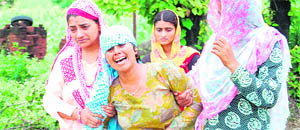 Grieving relatives of deceased former Head Constable Nazir Ahmed at their house in a village in Nagrota on Thursday.