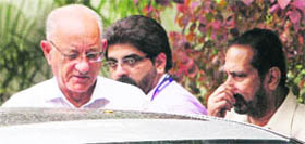 Commonwealth Games Federation (CWGF) President Michael Fennell and Organising Committee Chairman Suresh Kalmadi come out after meeting Sports Minister M S Gill (unseen) at his residence in New Delhi on Thursday.