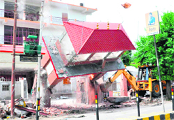 The main gate of an ashram being demolished at Devpura in Haridwar 