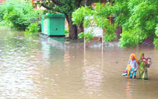 Patients waddle through water at the Civil Hospital in Rewari.