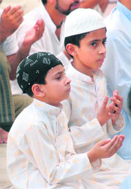 Boys offer namaaz during the holy month of Ramzan in Jammu on Friday.