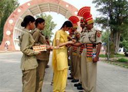 A student tying rakhi on the wrist of a BSF jawan at Hussainiwala JCP on Saturday. 