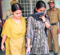An impersonator (right), who was appearing in the Common Entrance Test for MBBS, being taken out of the examination hall by the police at Jammu University on Saturday.