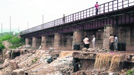 A view of the damaged foundation of a railway bridge over the Balole nullah at Bari Brahmana in Jammu.