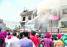 Fire tenders try to douse flames at Model Town on Saturday.