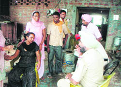 Relatives grieve in the house in Doraha where four members of a family were murdered.