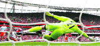 Arsenal's Theo Walcott scores his second goal against Blackpool during their English Premier League soccer match in London on Saturday