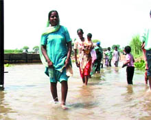The residents of Mohar Jamsher coming out of the village after water in the Sutlej rose on Sunday.