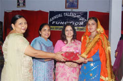 Amandeep Mann of the DAV College for Women being honoured on winning the title of Teej Queen in Ferozepur.