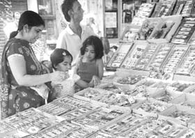 People buy rakhis from a shop ahead of the Raksha Bandhan in Patiala