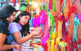 Girls look at rakhis at a shop in Sector 19, Chandigarh