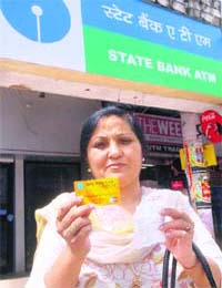 Sangeeta Arora shows her ATM card