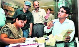 Food inspectors inspect food products at a restaurant during a raid in Dehradun on Sunday.