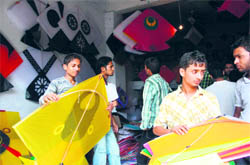 Boys select a kite at the Pacca Danga Market in Jammu on Sunday