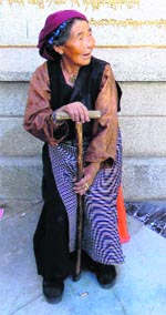 An elderly woman outside the monastery.