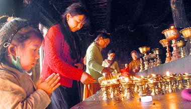 Choglamsar students pray for flood victims.