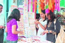 Girls buy rakhis in Haridwar on Monday. 