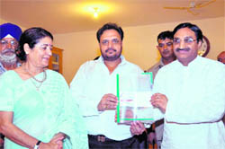 The Chairman of The Heritage School presents a cheque to CM Ramesh Pokhriyal Nishank 