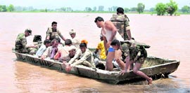 A rescue team evacuates villagers from a flood-hit area in Sirsa.