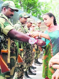 Members of the NSF tying rakhis on the wrists of BSF jawans at the octroi post in R.S. Pura, Jammu