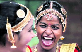 Deaf and mute dancers share a lighter moment before a practice session in New Delhi on Sunday.