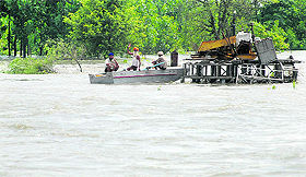 Residents of Burj village wait to ferry people across the flooded area to safe places in Anandpur Sahib on Monday.