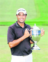 Arjun Atwal holds the championship trophy after winning the Wyndham Championship at Sedgefield Country Club in North Carolina on Sunday.
