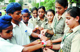 Girls of DD High School tie rakhis on the hands of boys of Centre Khalsa Yateem Khana in Amritsa