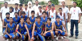 Winners (in blue dress) of the district basketball tournament along with runners-up, at Abohar