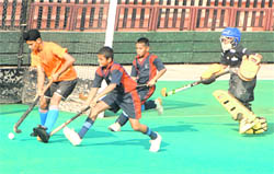 Players in action during a match between Surjit Academy Jalandhar and Baba Bakala match played at the Sector 42 Hockey Stadium, Chandigarh, on Tuesday.