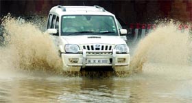 A car passes through a waterlogged stretch at Yamuna Bank in New Delhi on Tuesday.