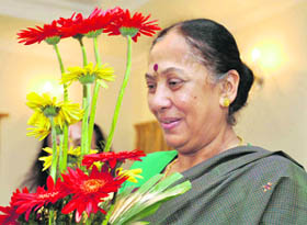 Uttarakhand Governor Margaret Alva appreciates flowers at the Raj Bhawan in Dehradun on Tuesday.