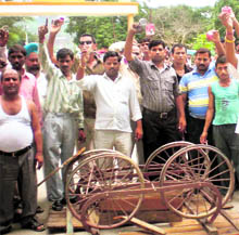 Members of the Small Vendors Association members hold a protest against the anti-encroachment drive in Haridwar