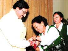 Tibetan women tie rakhi on the hand of Chief Minister Ramesh Pokhriyal Nishank on Raksha Bandhan in Dehradun onTuesday