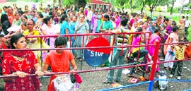 Women wait outside the Central Jail, Ambala, to tie rakhi to their brothers on Tuesday.