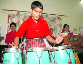 A visually disabled child performs during a function at a school in Behrampur in Gurgaon.